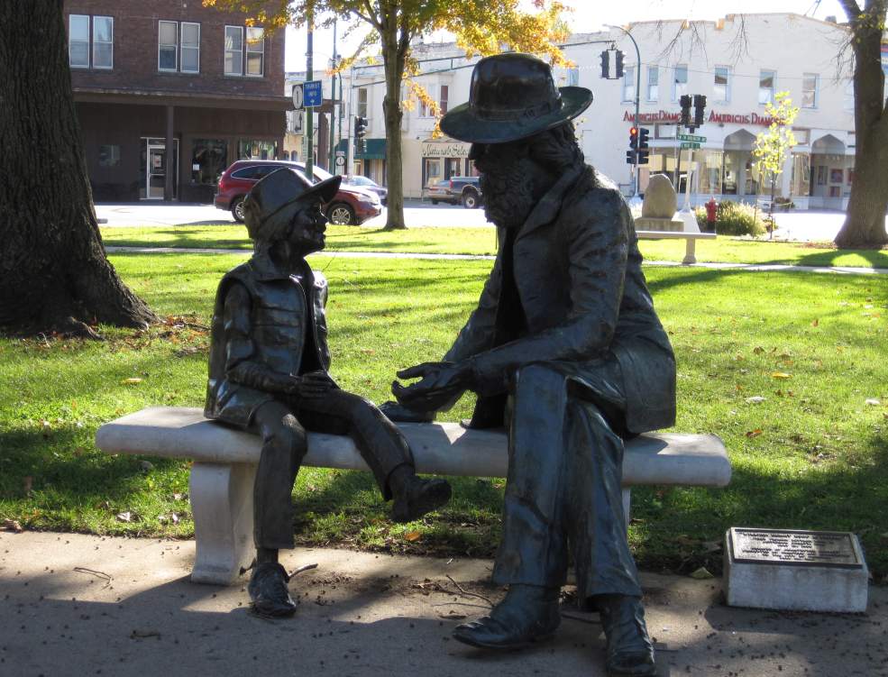 William Henry Coop was the first pioneer settler born in Jefferson County (1836). He and his young friend have been sitting in Central Park since 1981 (sculpted by Christopher Bennet).