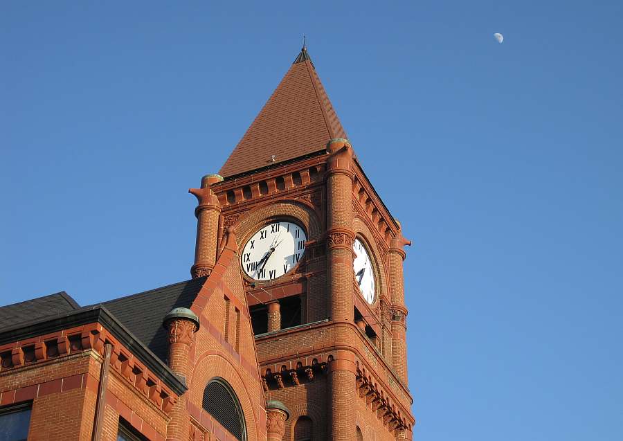 Clock tower with moon in the sky.